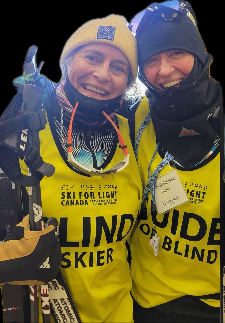 Photo of 2 female xc skiers posing with official jerseys. The person on the left being Lisa Bentz